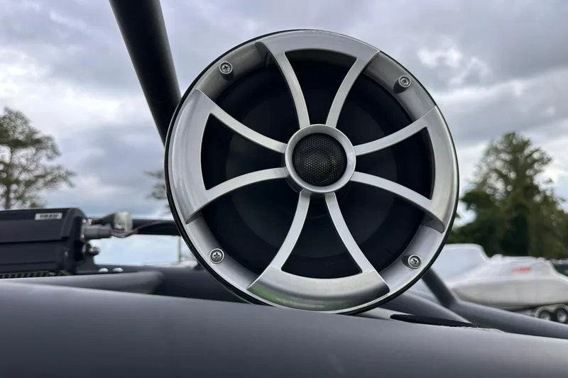 Slide: The Image of Close-up of a Yamaha Boats 255XD 2022 speaker against a cloudy sky. - 16