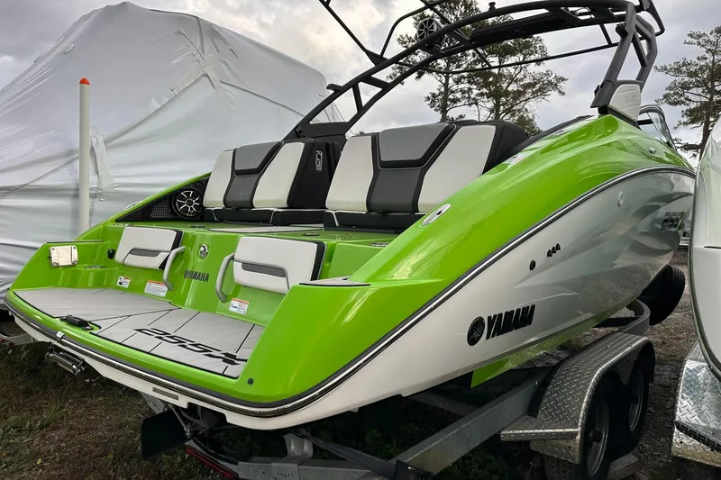 Slide: The Image of 2022 Yamaha Boats 255XD in vibrant green on trailer, rear view. - 17