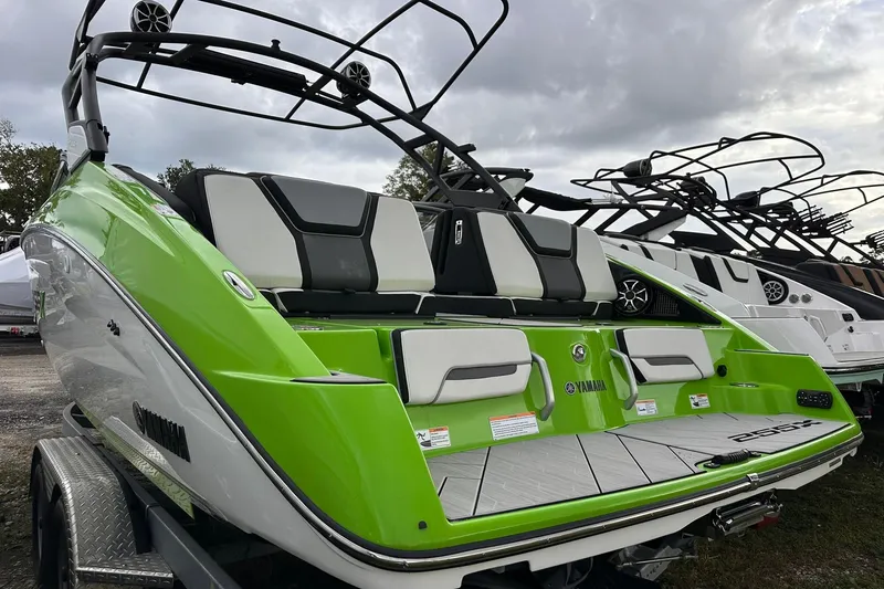 Slide: The Image of 2022 Yamaha Boats 255XD in vibrant green, showcasing sleek design and modern features. - 19