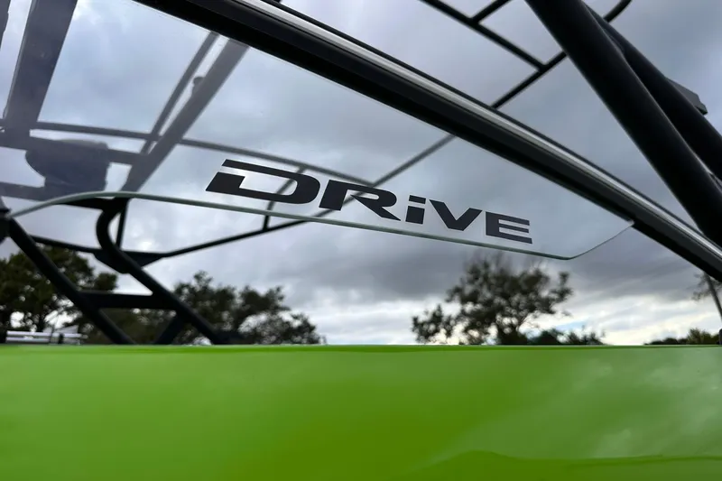 Slide: The Image of Yamaha Boats 2022 255XD with "DRiVE" logo on green exterior under cloudy sky. - 3