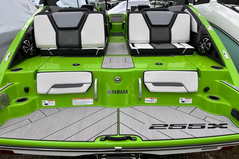 Slide: The Image of 2022 Yamaha Boats 255XD, vibrant green deck, sleek seating, modern design. - 5