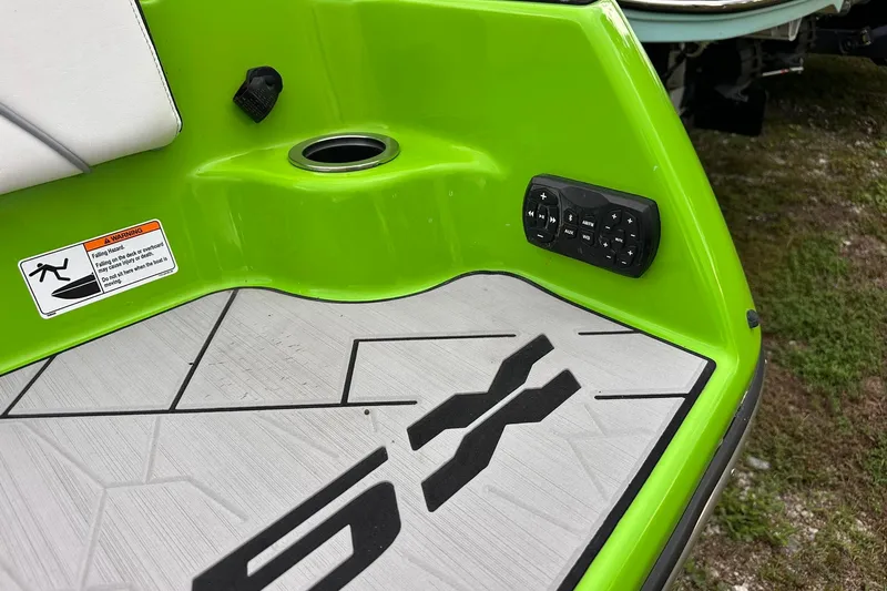 Slide: The Image of 2022 Yamaha Boats 255XD, green interior with control panel and warning label. - 6