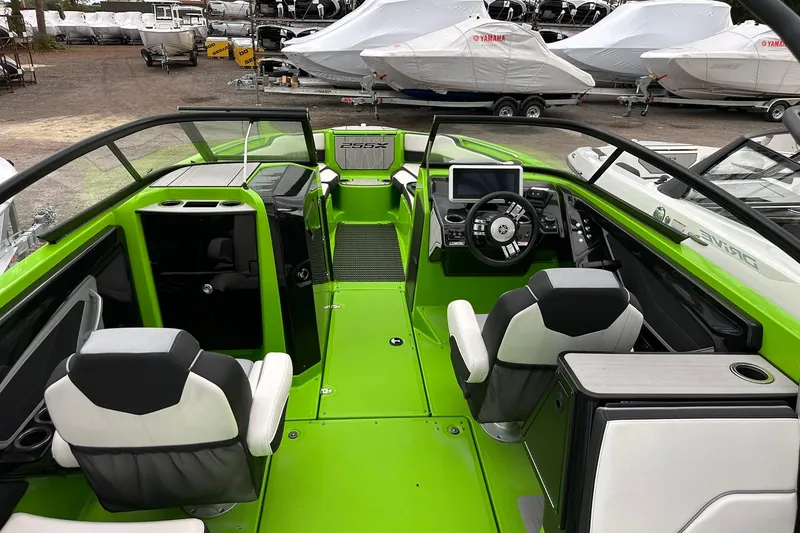 Slide: The Image of 2022 Yamaha Boats 255XD interior with vibrant green accents and modern dashboard. - 7