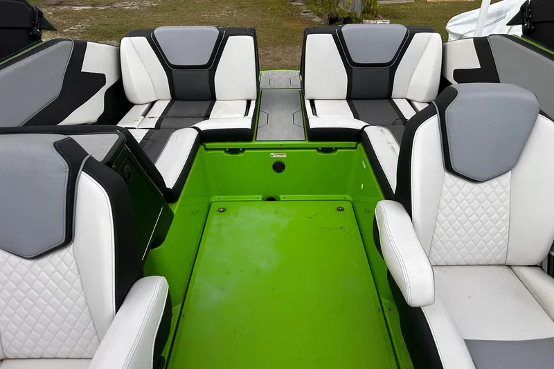 Slide: The Image of 2022 Yamaha Boats 255XD interior with green flooring and stylish seating. - 9