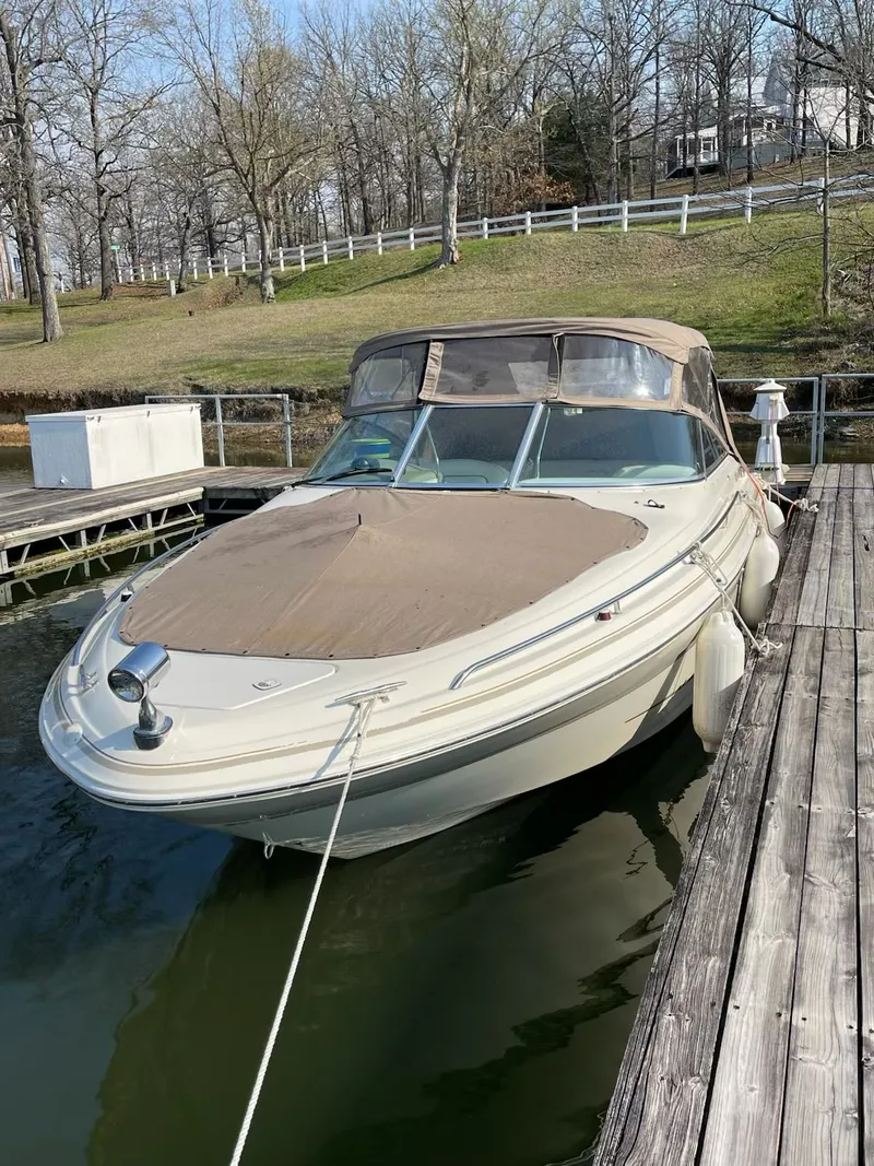 Slide: The Image of 1998 Sea Ray 280 Bow Rider docked, surrounded by trees. - 8