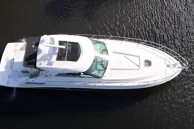 Slide: The Image of 2011 Sea Ray 450 Sundancer yacht docked near tropical waterfront home. - 12