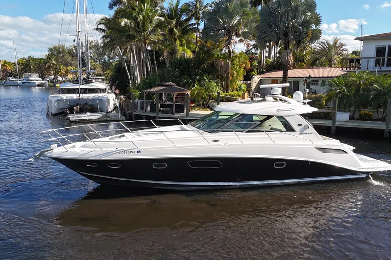 Slide: The Image of 2011 Sea Ray 450 Sundancer yacht cruising in a narrow waterway. - 14