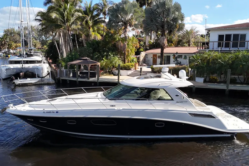 Slide: The Image of 2011 Sea Ray 450 Sundancer yacht cruising in a scenic, tropical marina. - 15
