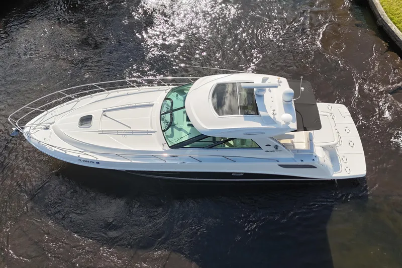 Slide: The Image of 2011 Sea Ray 450 Sundancer yacht docked, featuring spacious seating and sleek design. - 17