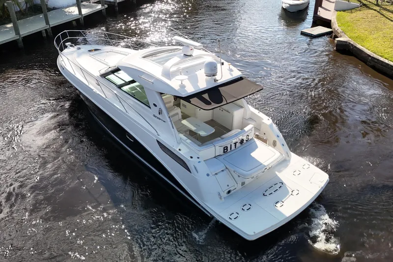 Slide: The Image of Interior helm of 2011 Sea Ray 450 Sundancer yacht, featuring modern controls and steering wheel. - 18