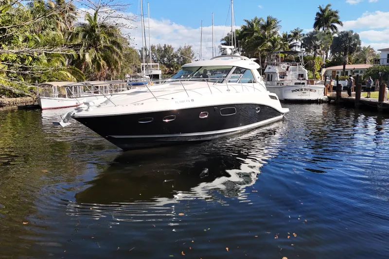 Slide: The Image of 2011 Sea Ray 450 Sundancer interior with luxurious seating and scenic water view. - 20