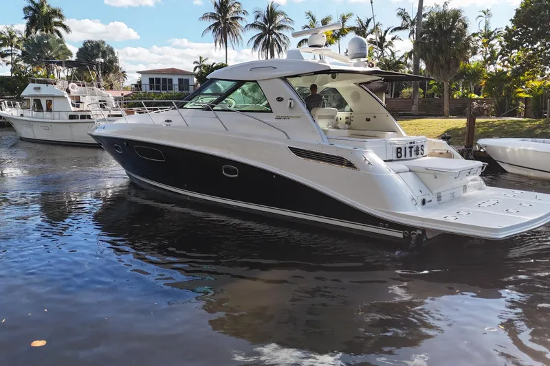 Slide: The Image of Luxurious interior of 2011 Sea Ray 450 Sundancer yacht docked by the water. - 22