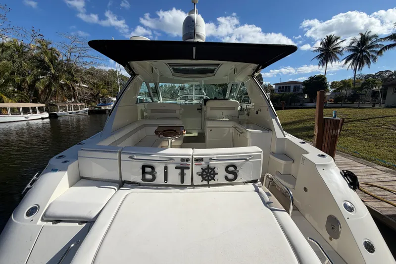 Slide: The Image of Luxurious seating area on a 2011 Sea Ray 450 Sundancer yacht by the water. - 24