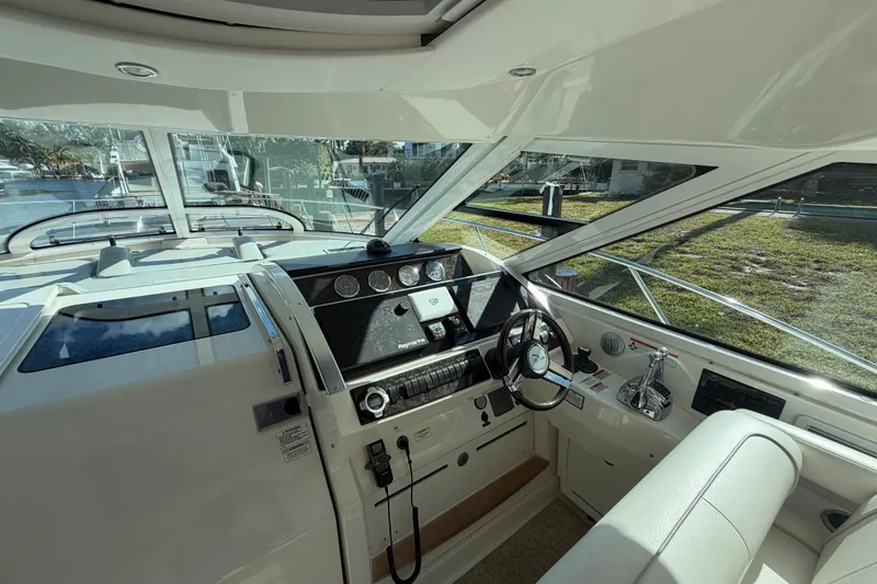 Slide: The Image of 2011 Sea Ray 450 Sundancer docked in a scenic canal with lush greenery. - 25