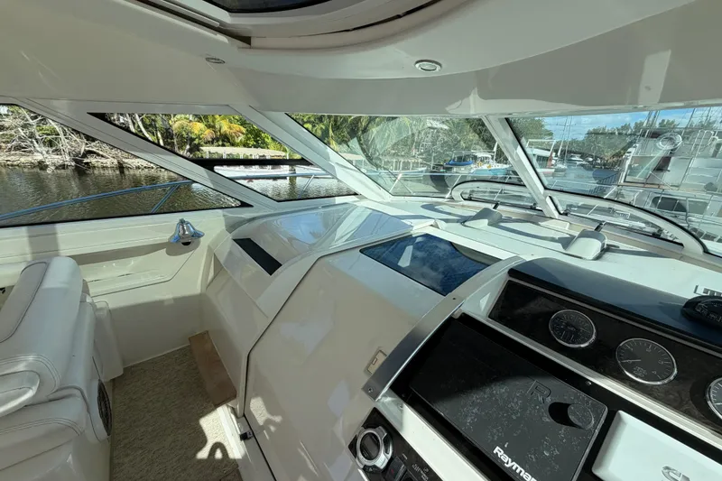 Slide: The Image of Dashboard of 2011 Sea Ray 450 Sundancer with navigation screens and gauges. - 26