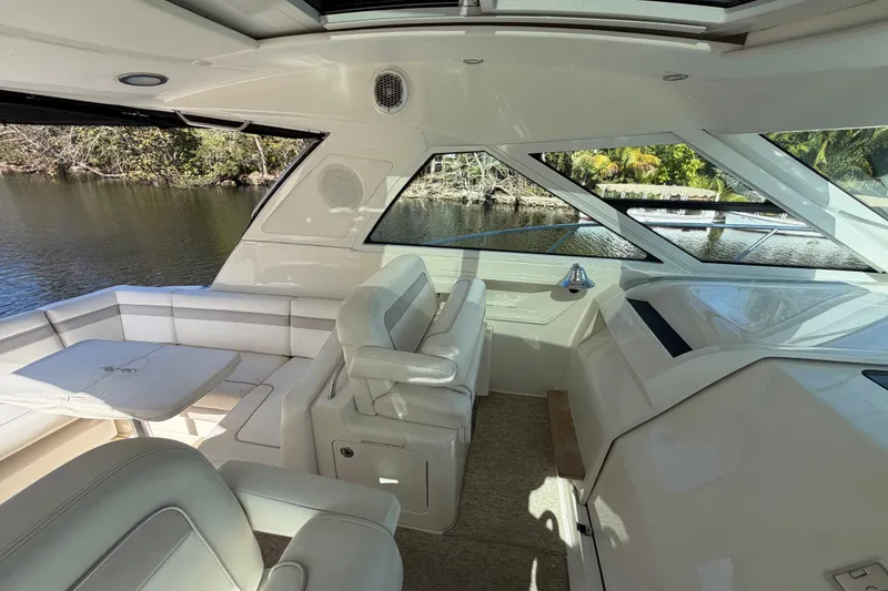 Slide: The Image of 2011 Sea Ray 450 Sundancer helm with steering wheel and control panel. - 27