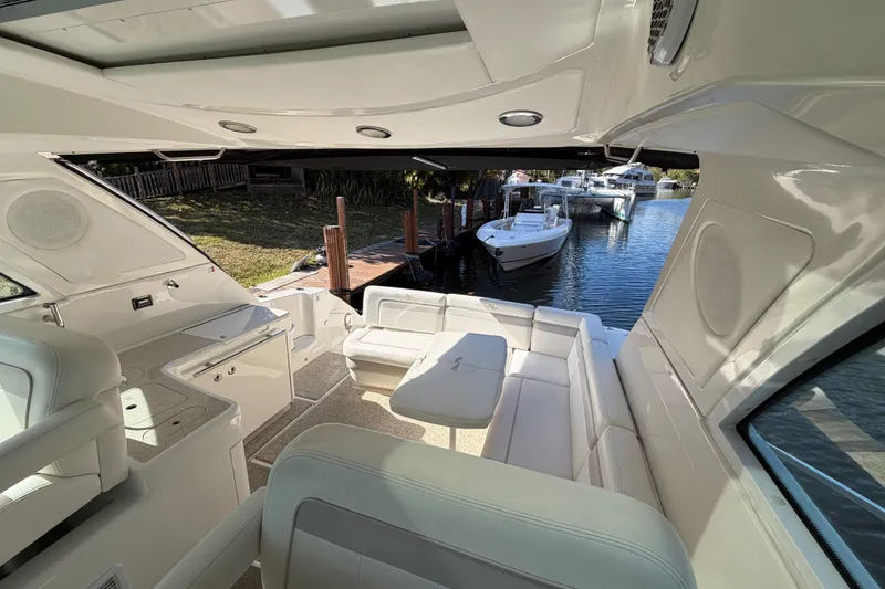 Slide: The Image of 2011 Sea Ray 450 Sundancer yacht cruising on a scenic river with lush greenery. - 28