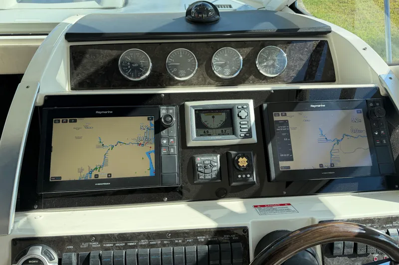 Slide: The Image of Interior view of 2011 Sea Ray 450 Sundancer yacht with wooden flooring and seating area. - 33