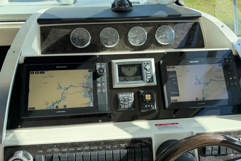 Slide: The Image of Interior of 2011 Sea Ray 450 Sundancer yacht with elegant seating and wooden finishes. - 34