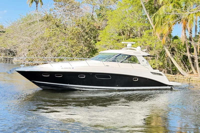 Slide: The Image of Interior of 2011 Sea Ray 450 Sundancer yacht with wood paneling and modern amenities. - 41