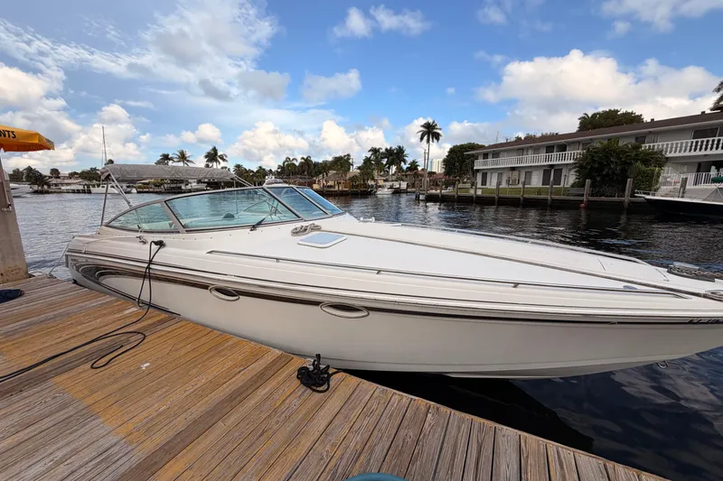Slide: The Image of 2002 Formula 330 Sun Sport boat docked by waterfront homes under a blue sky. - 10