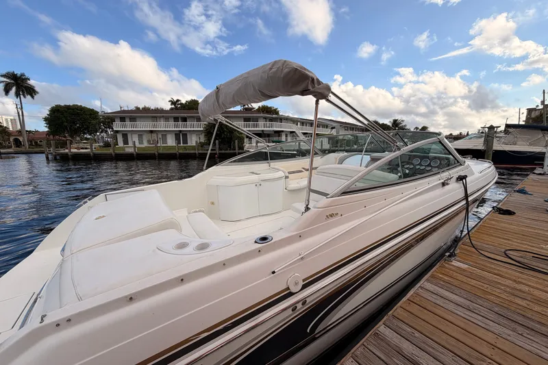 Slide: The Image of 2002 Formula 330 Sun Sport boat docked by waterfront homes under a blue sky. - 11