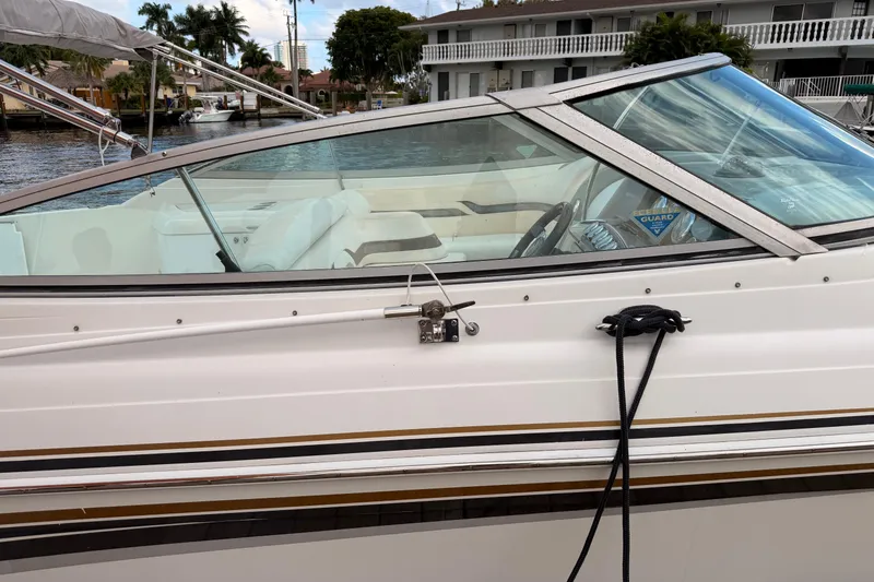 Slide: The Image of 2002 Formula 330 Sun Sport boat docked, featuring sleek design and white interior. - 14