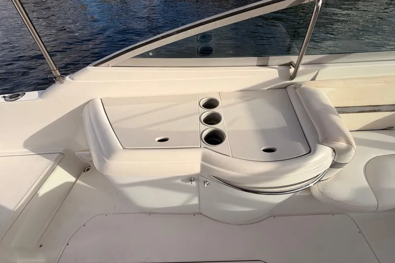 Slide: The Image of 2002 Formula 330 Sun Sport boat interior with cup holders and seating by the water. - 22