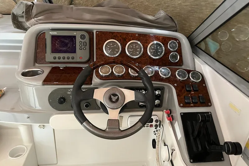 Slide: The Image of Dashboard of a 2002 Formula 330 Sun Sport boat with steering wheel and gauges. - 24