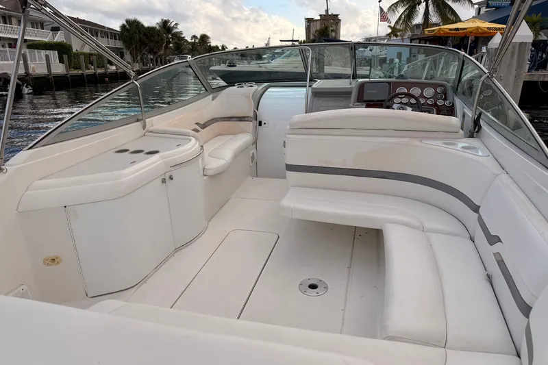 Slide: The Image of 2002 Formula 330 Sun Sport boat interior with white seating and control panel. - 36