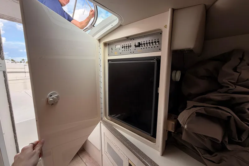 Slide: The Image of 2002 Formula 330 Sun Sport interior with open cabinet and control panel. - 44