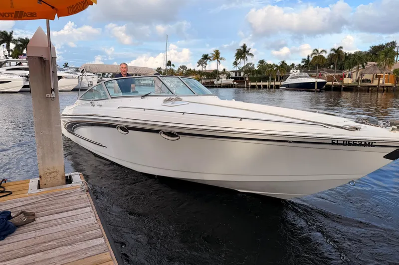 Slide: The Image of 2002 Formula 330 Sun Sport boat docked on a sunny day with palm trees in the background. - 5