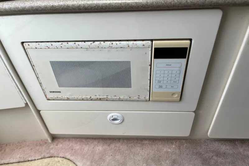 Slide: The Image of Built-in Samsung microwave in 2002 Formula 330 Sun Sport boat kitchen. - 50
