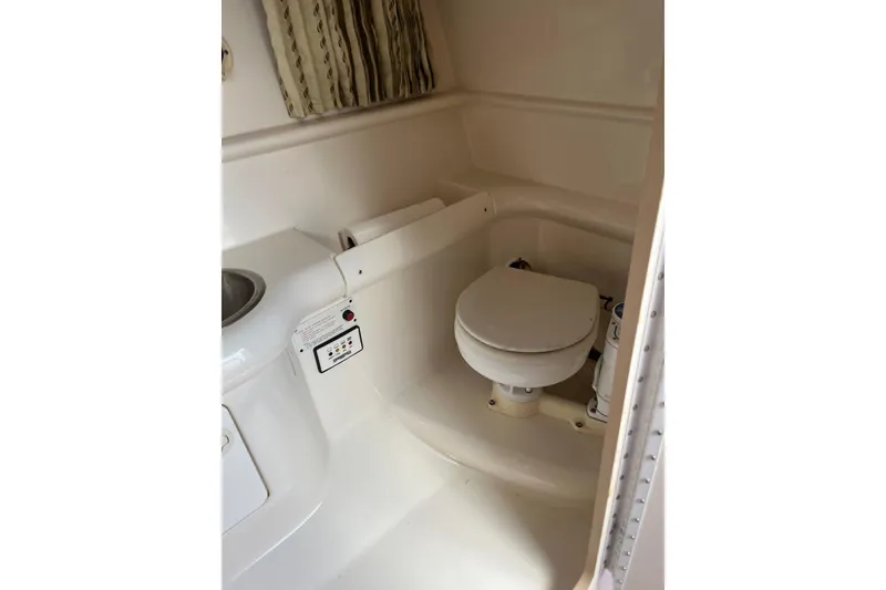 Slide: The Image of 2002 Formula 330 Sun Sport boat bathroom with toilet and sink. - 51