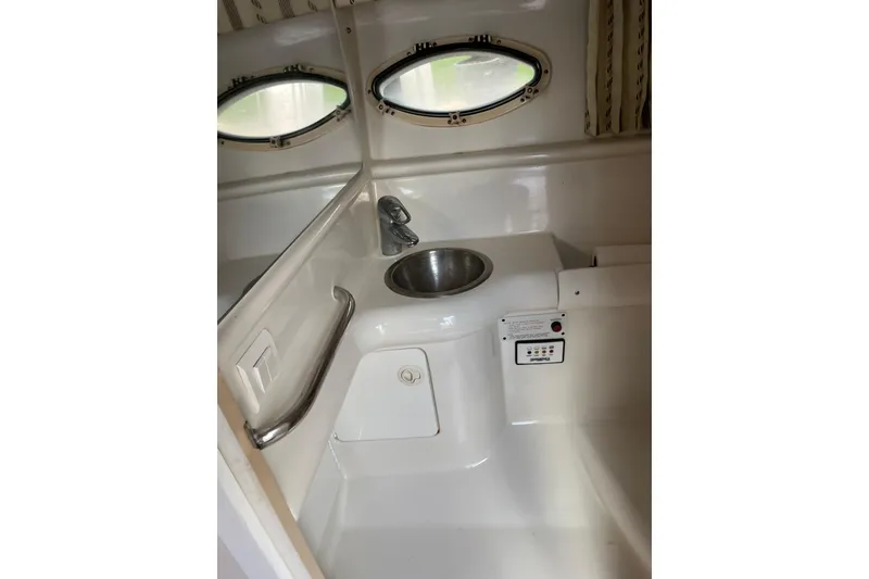 Slide: The Image of 2002 Formula 330 Sun Sport boat interior with sink and porthole windows. - 52