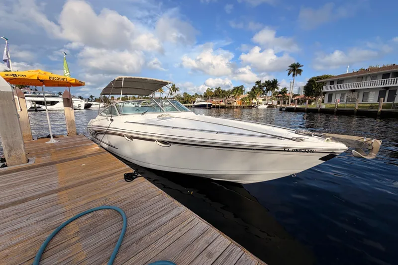 Slide: The Image of 2002 Formula 330 Sun Sport boat docked at a marina under a partly cloudy sky. - 6