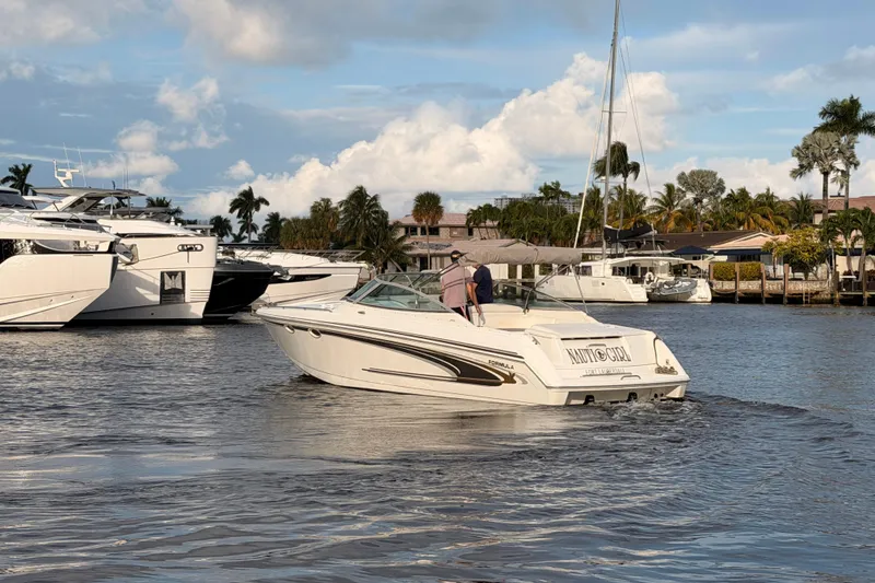Slide: The Image of 2002 Formula 330 Sun Sport boat cruising on a sunny day near a marina. - 63