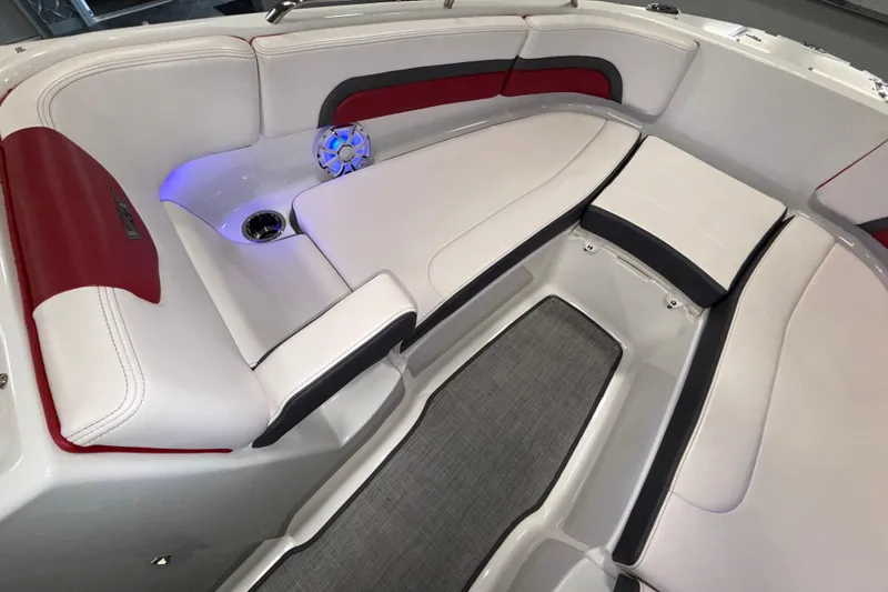 Slide: The Image of 2019 Chaparral Vortex 2430 VRX boat interior with white and red seating, speaker, and cup holder. - 13
