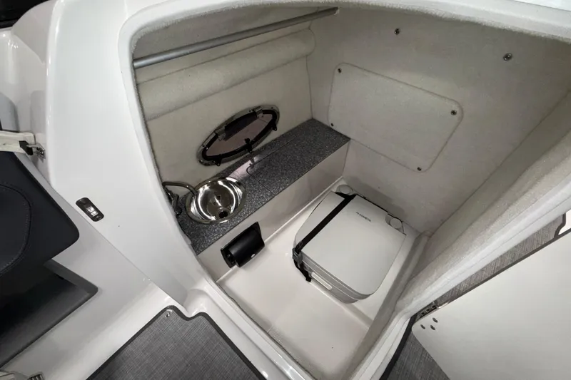 Slide: The Image of 2019 Chaparral Vortex 2430 VRX boat interior with compact toilet and sink. - 16