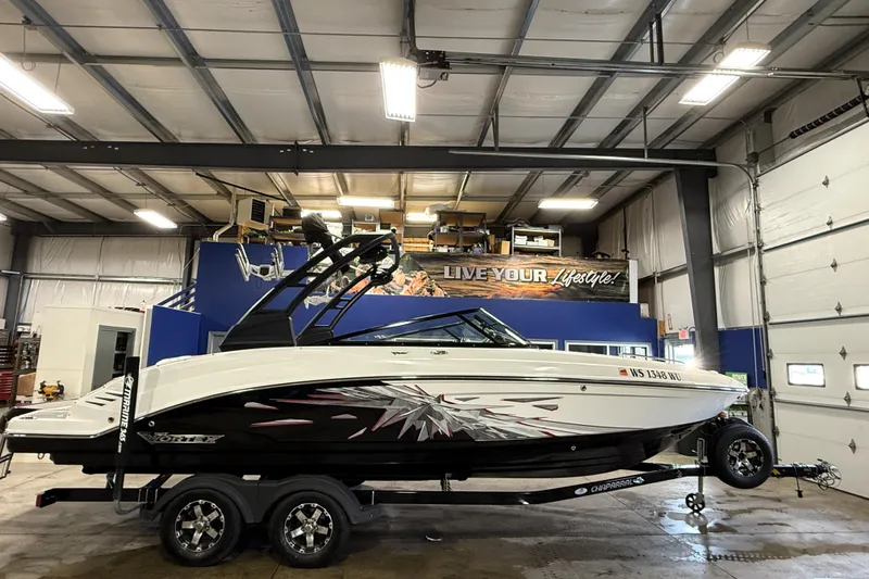 Slide: The Image of 2019 Chaparral Vortex 2430 VRX boat in a garage, side view. - 2