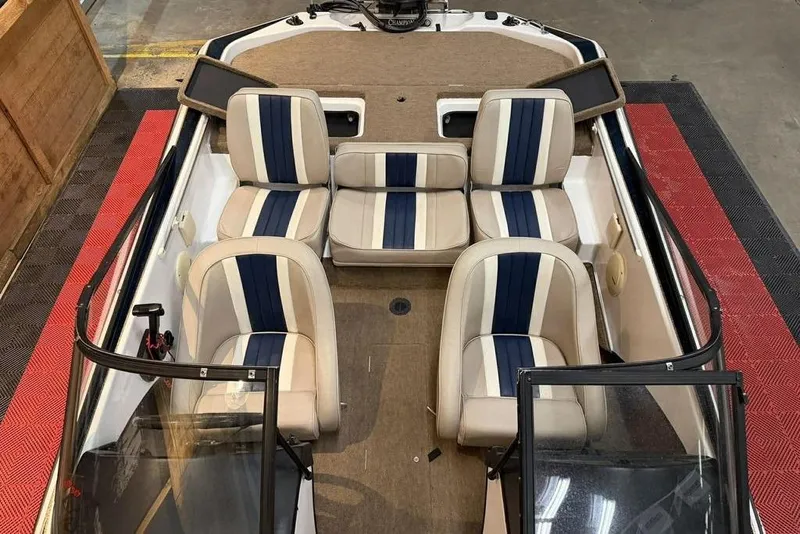 Slide: The Image of 1999 Champion 181 SX boat interior with beige and blue seating arrangement. - 4