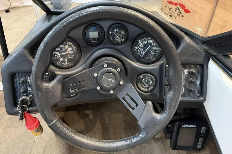 Slide: The Image of Dashboard of a 1999 Champion 181 SX boat with steering wheel and gauges. - 6