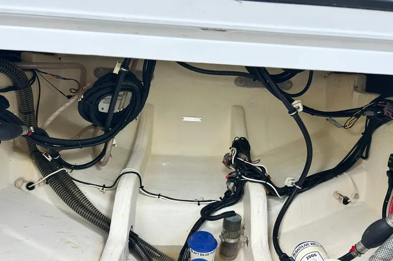Slide: The Image of 2021 Edgewater 340CC boat wiring and plumbing system in the engine compartment. - 10