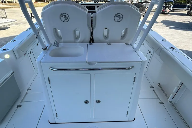 Slide: The Image of 2021 Edgewater 340CC boat interior with sink and storage area. - 11