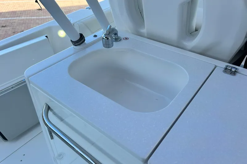 Slide: The Image of 2021 Edgewater 340CC boat sink with faucet and rod holders. - 14