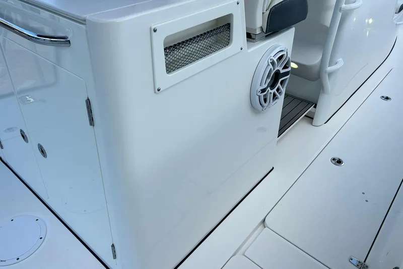 Slide: The Image of 2021 Edgewater 340CC boat interior with speaker and storage compartment. - 16