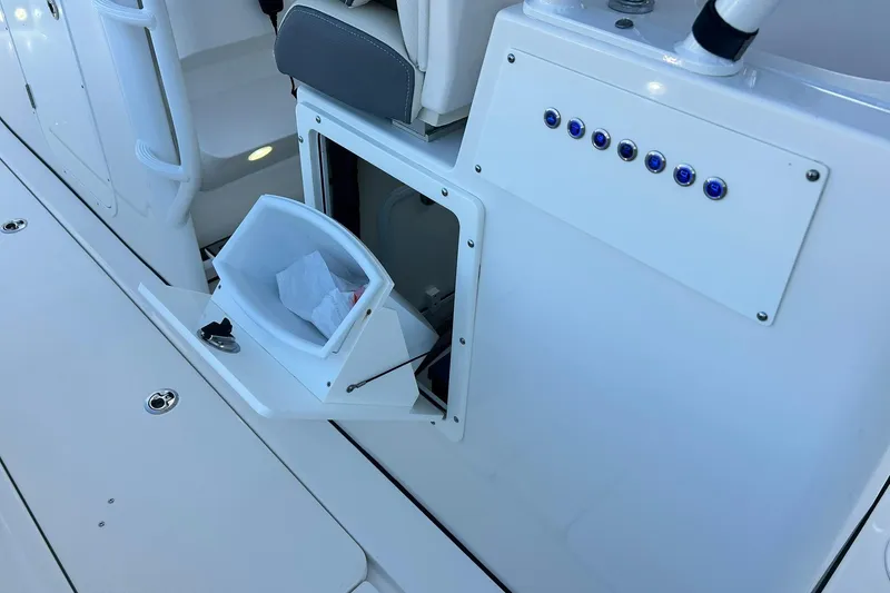 Slide: The Image of 2021 Edgewater 340CC boat interior with storage compartment and control panel. - 18