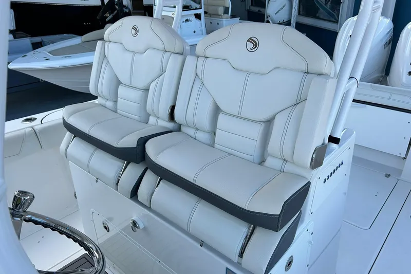 Slide: The Image of Luxury seating on a 2021 Edgewater 340CC boat, featuring plush white upholstery. - 19