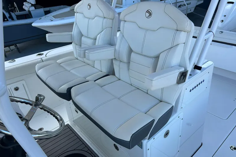 Slide: The Image of 2021 Edgewater 340CC boat with luxurious white captain's seats and steering wheel. - 20