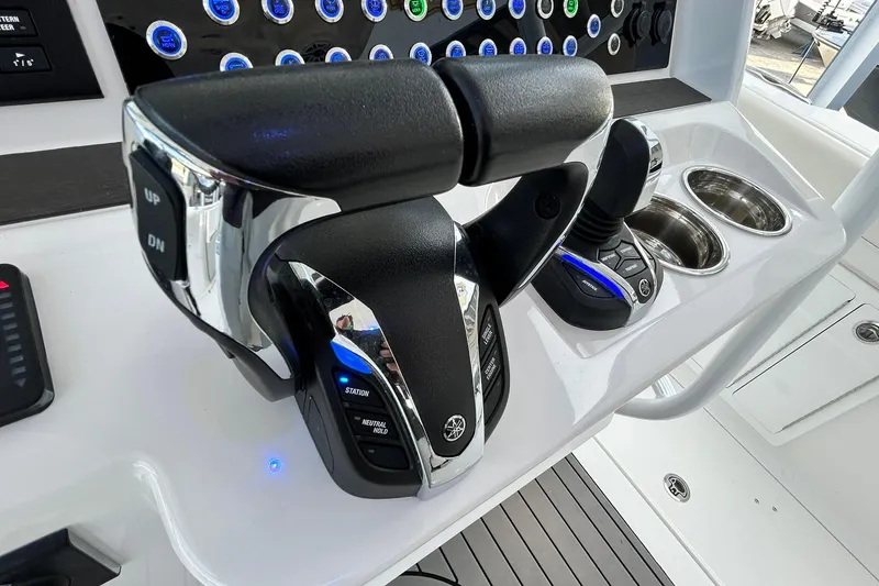 Slide: The Image of Edgewater 340CC 2021 boat controls with dual throttle levers and joystick. - 22